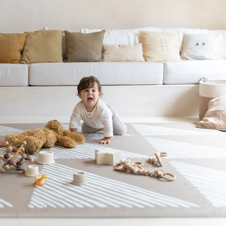 a baby was crawling on the play mat