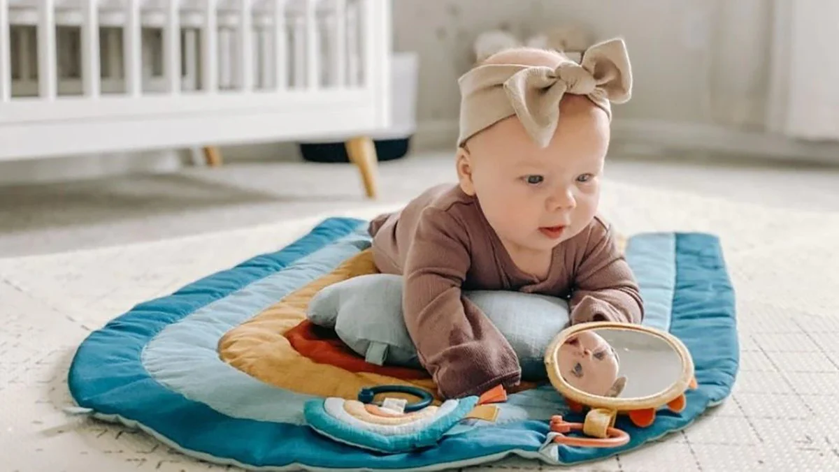 baby lying on play mat